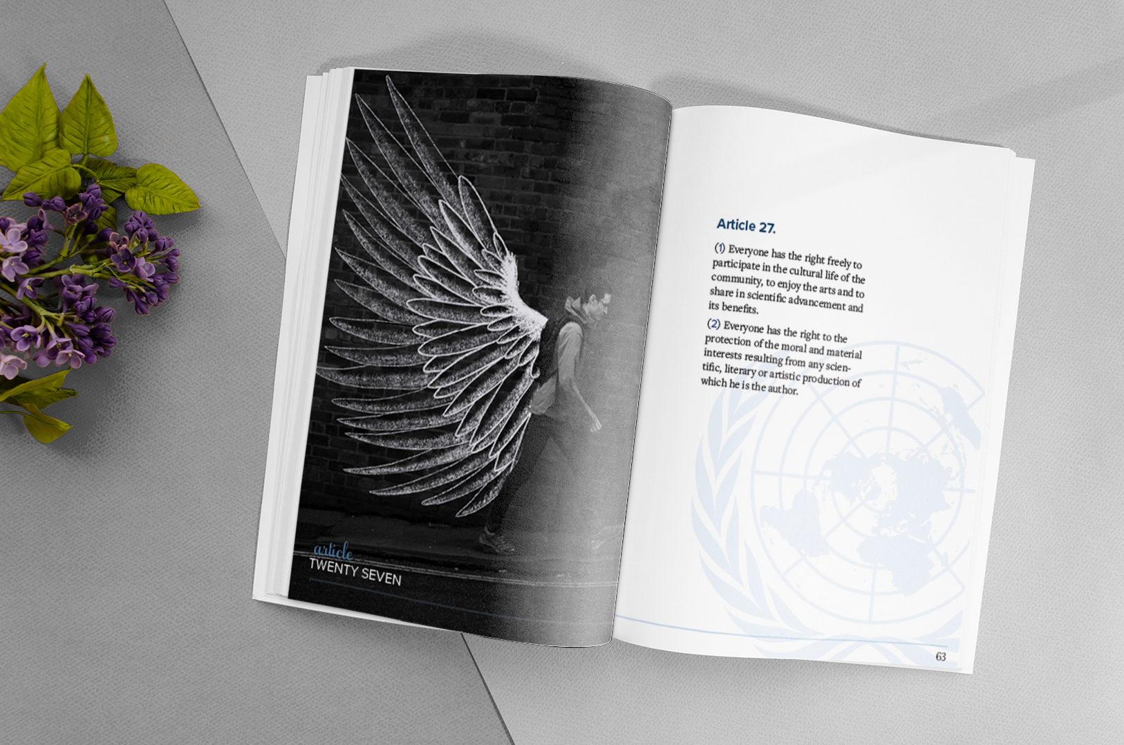 The UN booklet open to a spread showing text from article 27, and a man walking with graffiti wings drawn on.