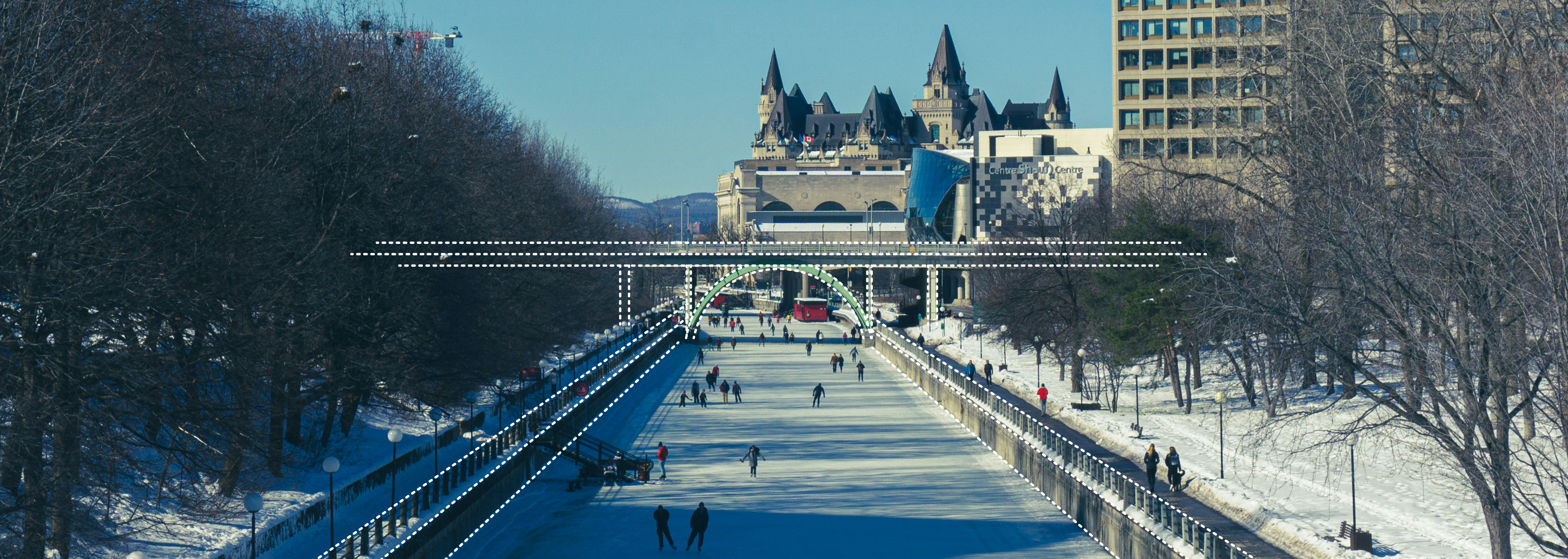 Image along the Ottawa Rideau Canal near Laurier Avenue Bridge in winter, with skaters on the ice.