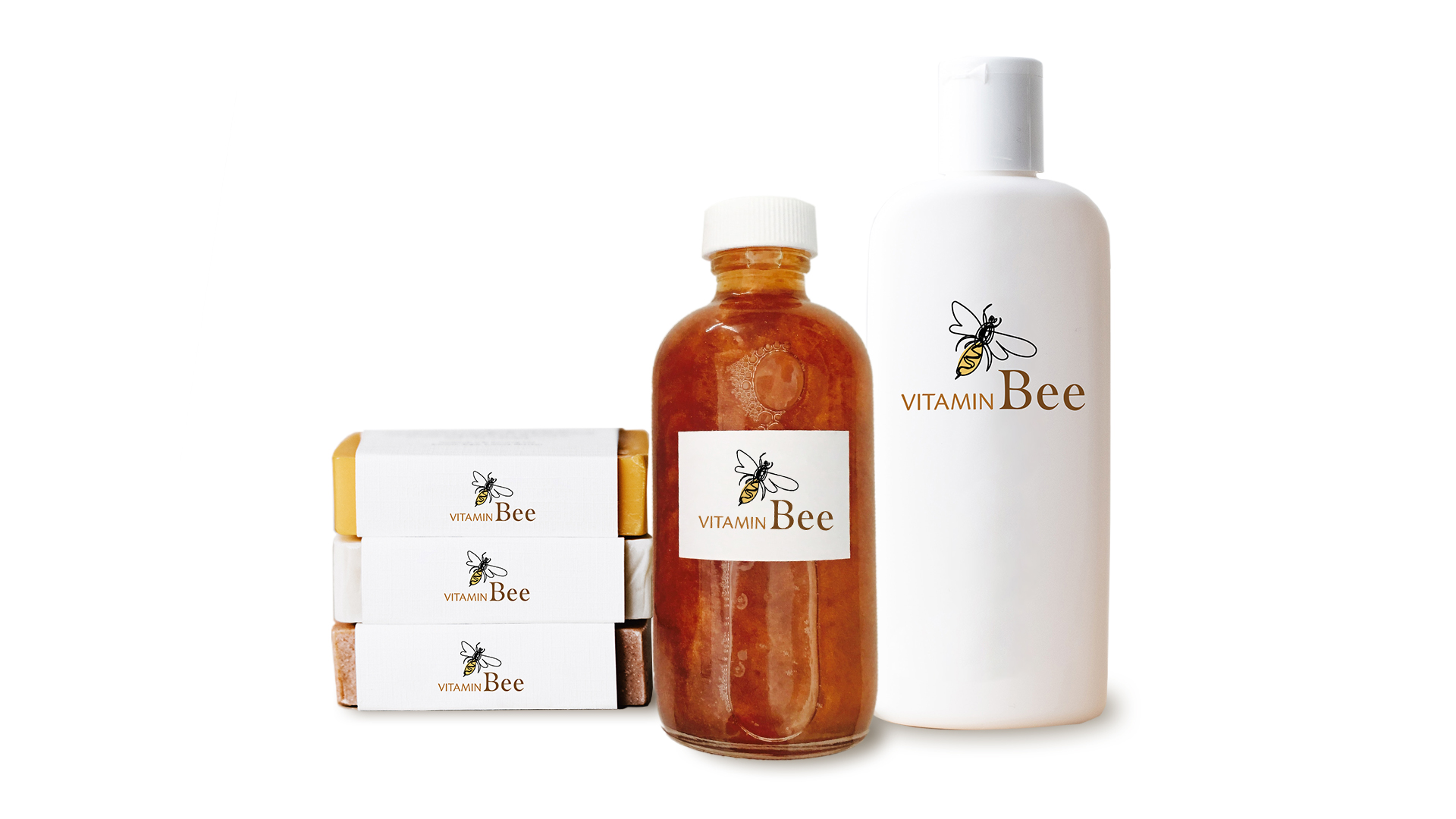 Two bottles and three pieces of soap with the Vitamin Bee branding.
